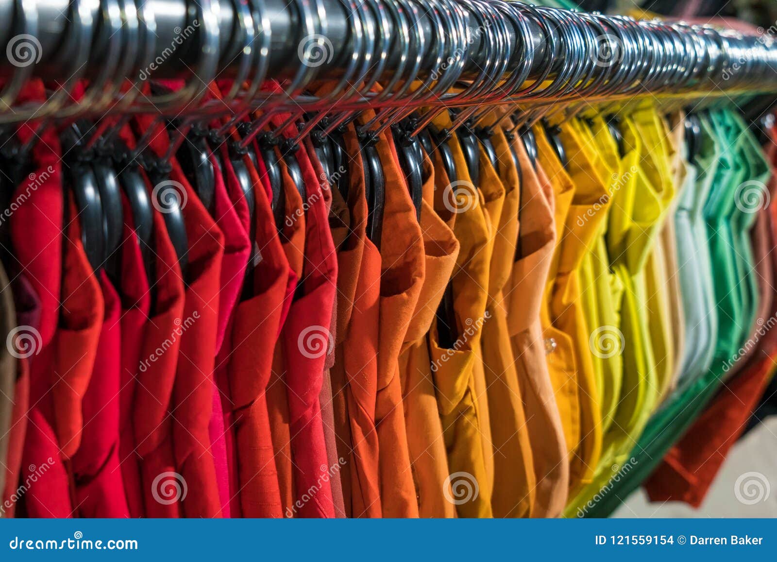 male mens shirts on hangers in thrift shop or wardrobe closet ra